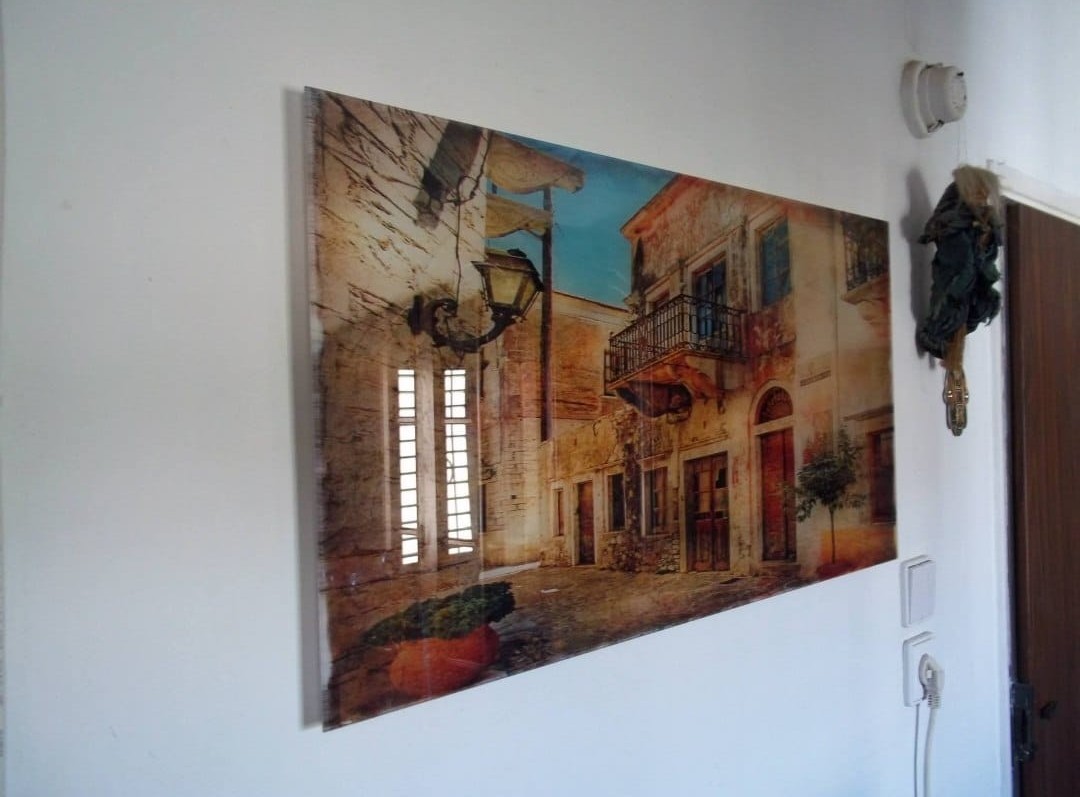 A glass wall panel carries a scene of an old city.